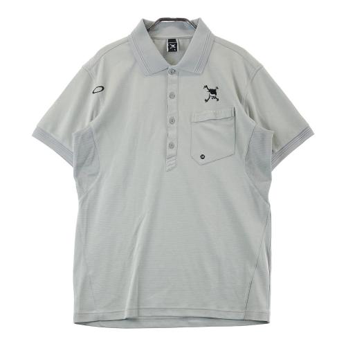 サイズ：M OAKLEY オークリー 433620JP 半袖 ポロシャツ スカル ボーダー柄 グレー系 [240101373492] ゴルフウェア メンズ ストスト OAKLEY オークリー 433620JP 半袖 ポロシャツ スカル ボーダー柄